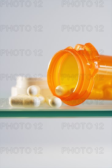 Close up of pill bottle with pills spilled out.