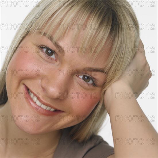 Studio shot of woman smiling.