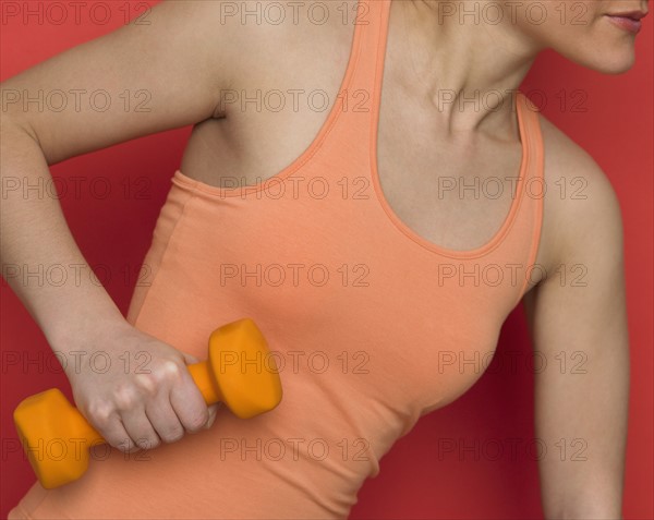 Woman working out with dumbbell.