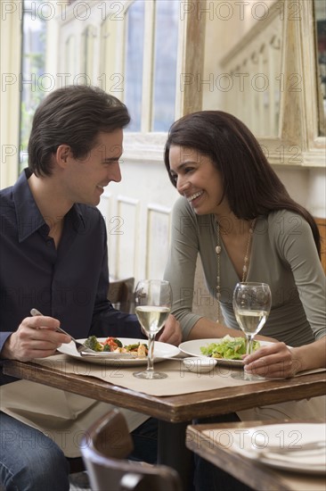 Couple eating at restaurant.