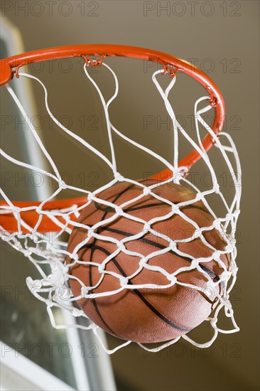 Close up of basketball in hoop.