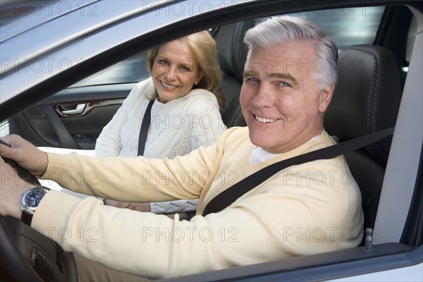 Senior couple driving in car.