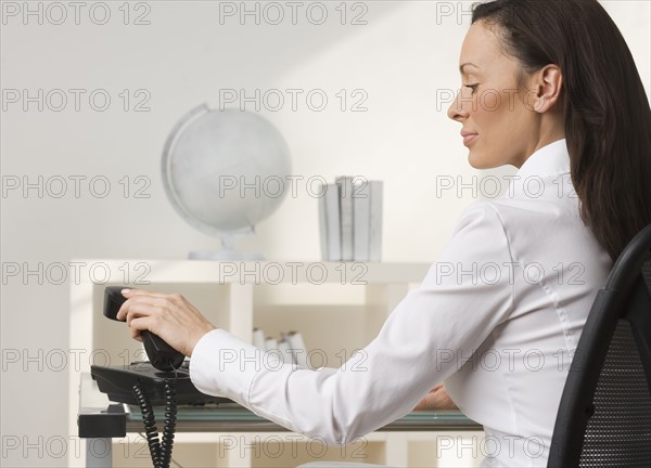 Businesswoman using phone.