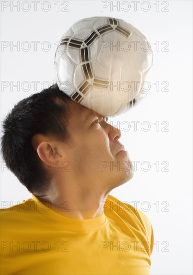 Man playing with soccer ball.