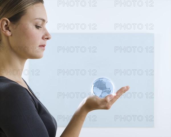 Woman holding small globe.