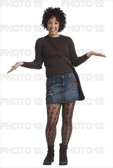 Studio shot of woman smiling with hands out.