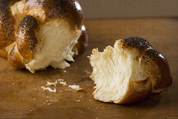 Piece of Challah bread broken off of loaf.