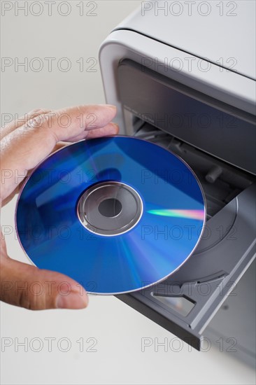 Close up of cd being inserted in to cd rom drive.