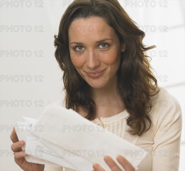 Portrait of woman holding mail.