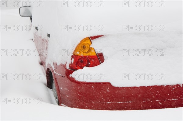 Car buried in snow in winter.