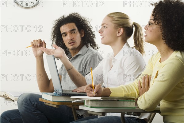 Three college students in class.