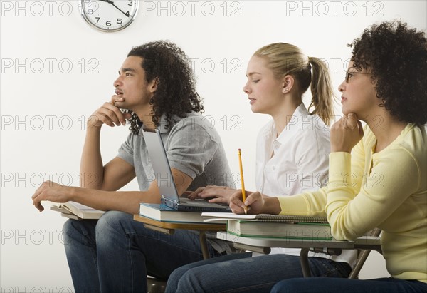 Three college students in class.