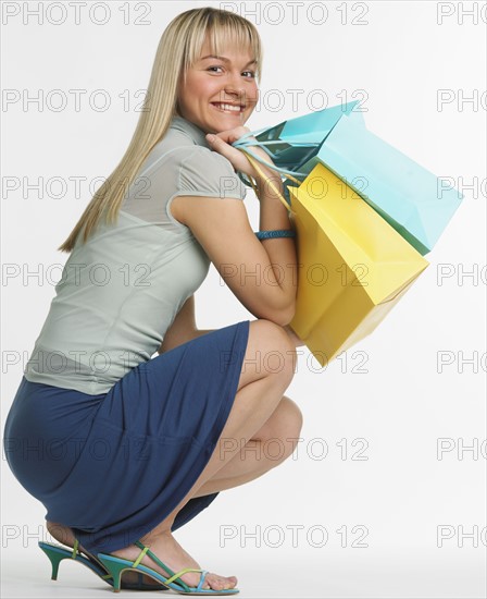 Studio shot of woman with shopping bags.