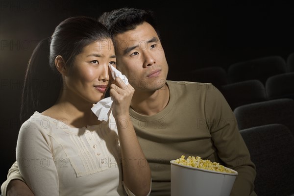 Couple watching a sad movie.