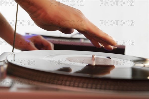 Person mixing sound from records.