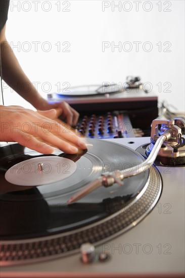 Person mixing sound from records.