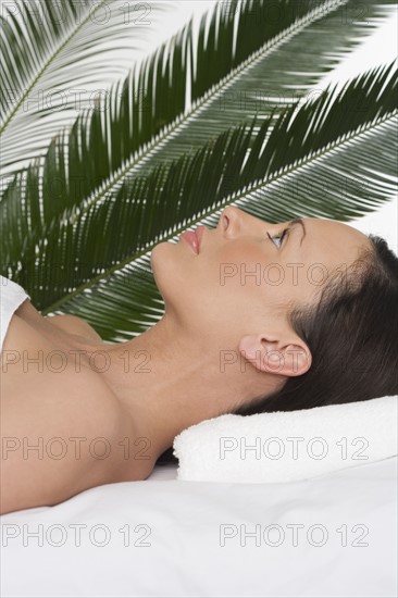 Woman lying on her back at spa.