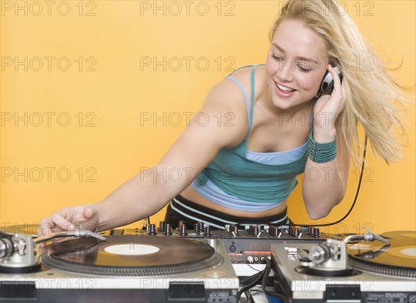 Woman working at a mixing board.