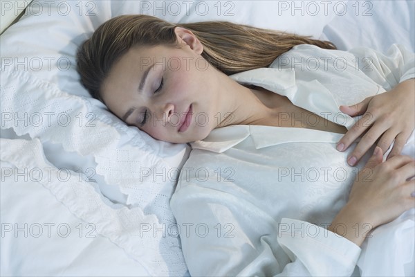 Woman sleeping in bed.