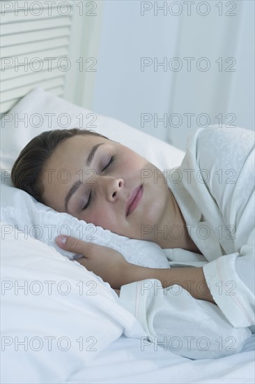 Woman sleeping in bed.