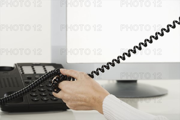 Woman talking on telephone.