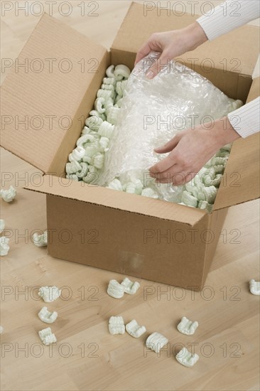 Woman unpacking a box.