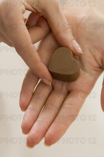 Woman holding chocolate candy.