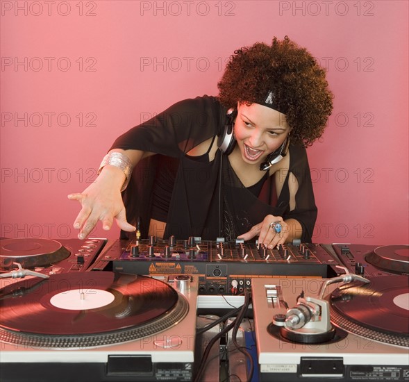 Woman working at a mixing board.