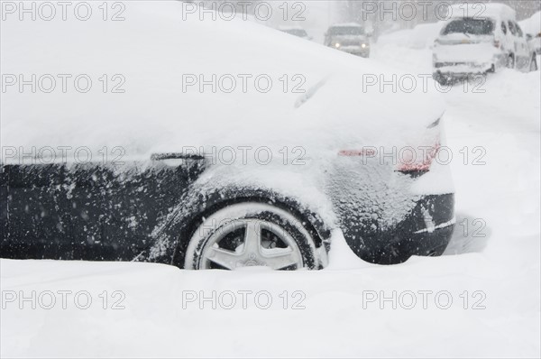 Car buried in snow in winter.