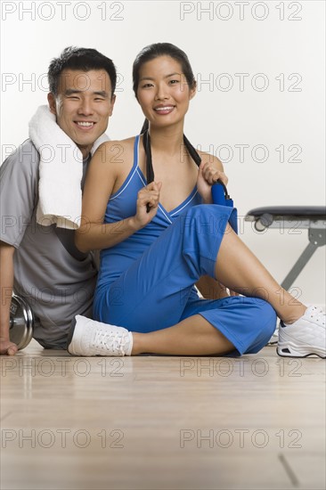 Portrait of man and woman working out.