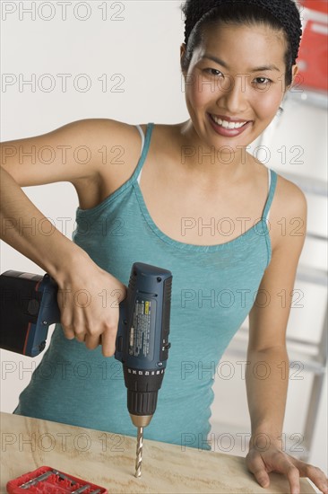 Portrait of woman doing home repairs.