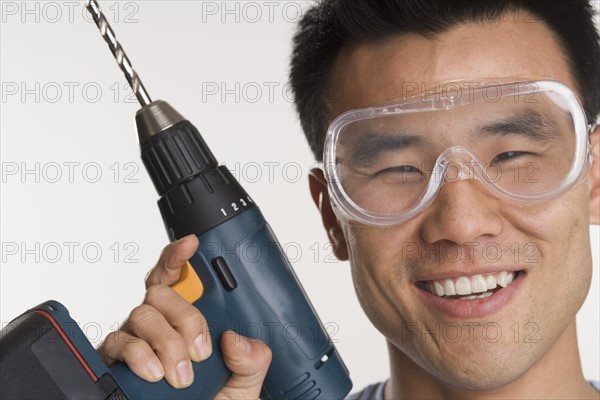 Portrait of man with electric drill.