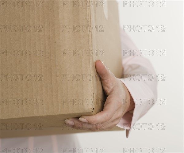 Woman carrying a box.