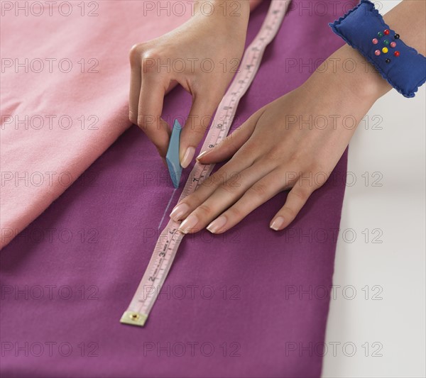 Close up of woman cutting fabric.