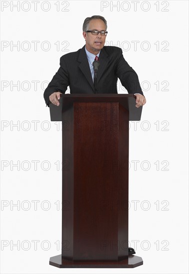 Businessman speaking at podium.