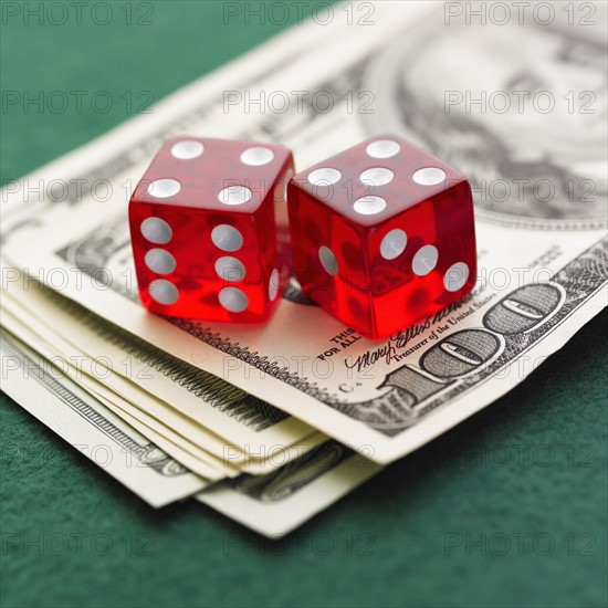 Still life of pair of dice and money.