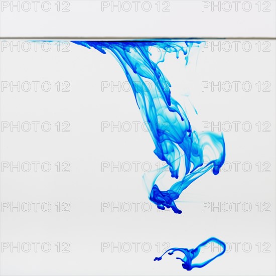 Blue dye floating in water.