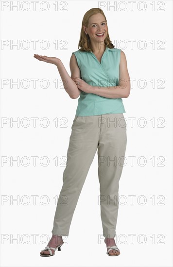 Studio shot of woman with hand held out to side.