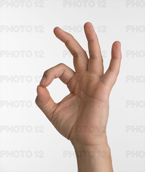 Studio shot of hand giving the okay sign.