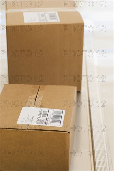 Shipping boxes with labels on conveyor belt.
