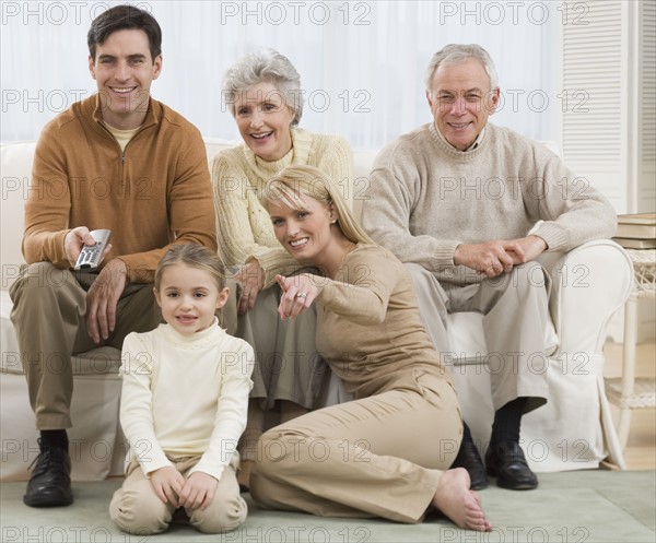 Multi-generational family watching television.