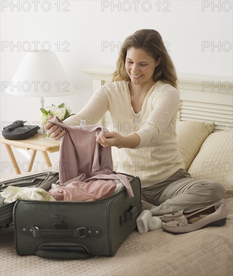 Woman unpacking in hotel room.