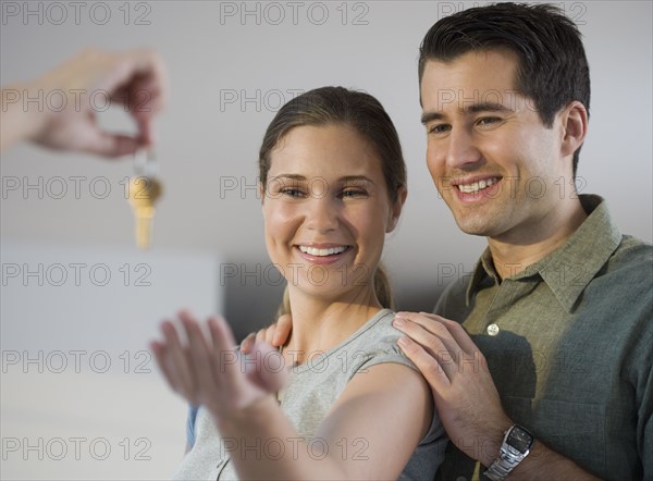 Portrait of couple receiving keys.