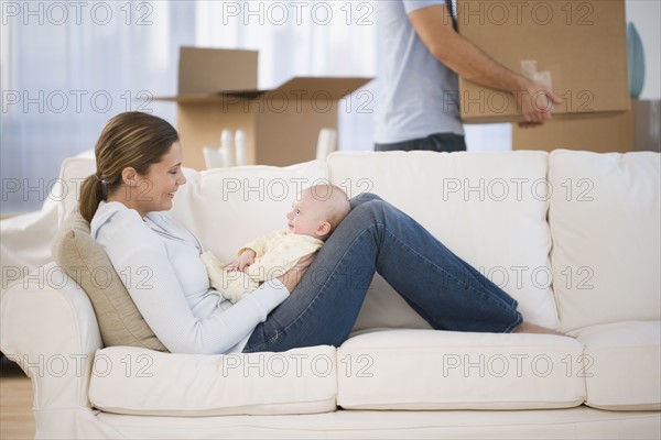 Mother smiling at baby in new house.