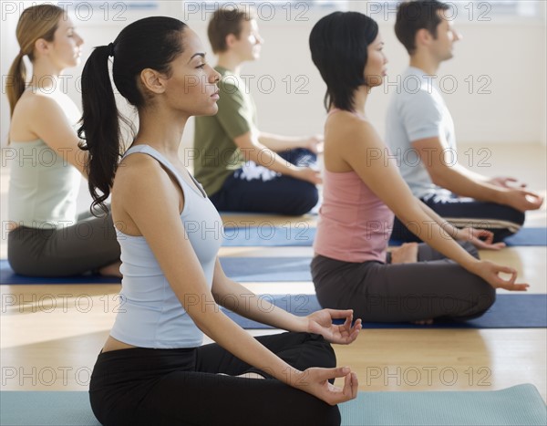 Group of people practicing yoga.