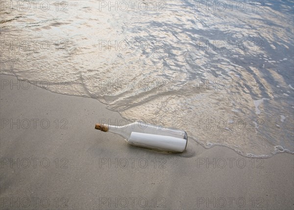 Message in bottle on beach.