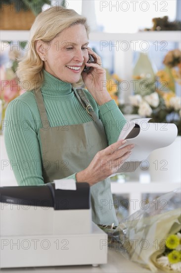 Female florist talking on telephone.