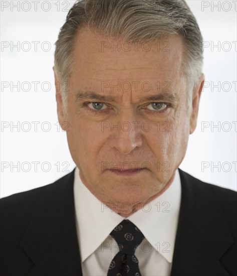 Close up of senior man wearing jacket and necktie.