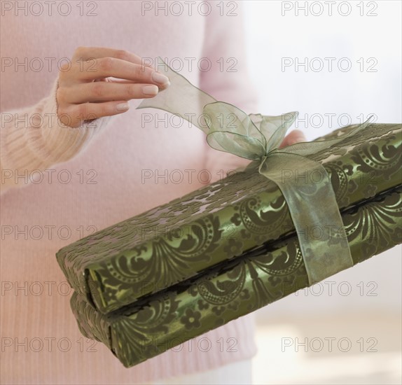 Close up of woman opening gift.