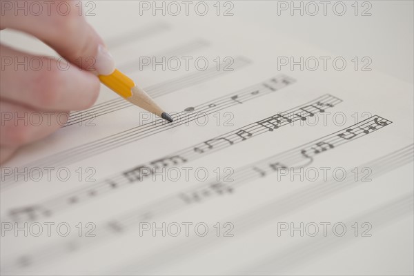 Close up of woman writing music.